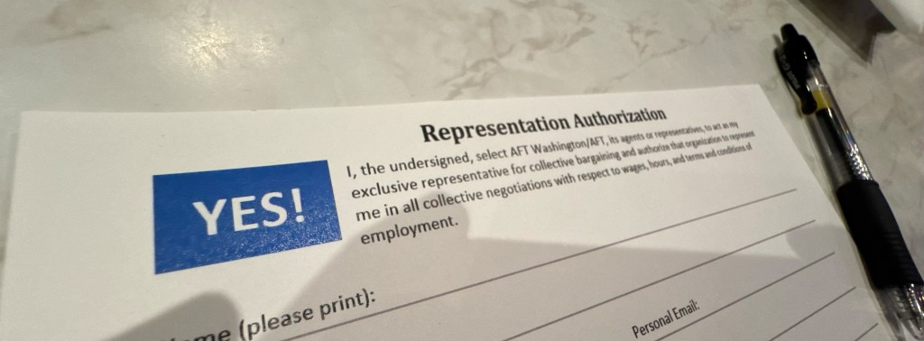 An AFT representation authorization card on a marble table with a pen sitting next to it.